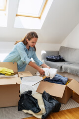 Brunette woman packing donation, concept of charity.