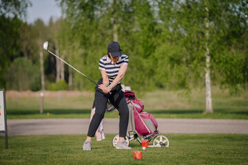 Golfer sport course golf ball fairway. People lifestyle woman playing game golf and hitting go on green grass. Female player game shot in summer.  Healthy and Sport outdoor