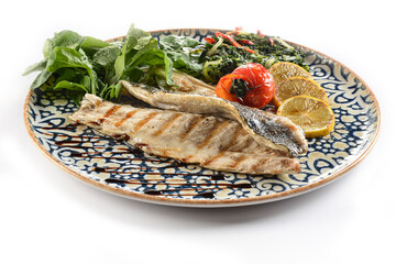 Trout baked in butter with spinach, tomato, rocket and lemon
