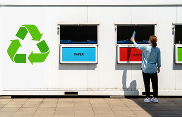 Separate waste collection point on street and person throwing plastic trash in garbage bin.