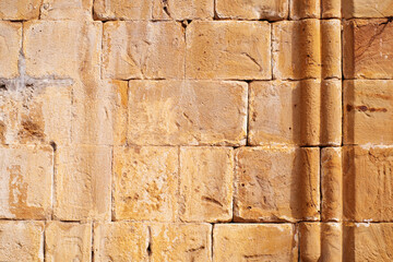 A wall of stone blocks with carved columns of an ancient temple in the Ananuri fortress. Texture background of ancient temple wall