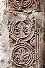 Floral bas-relief on the facade of an ancient temple in Georgia. Architectural decorative element, background