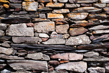 Ancient wall, old laying of walls from a stone. Textural grunge background