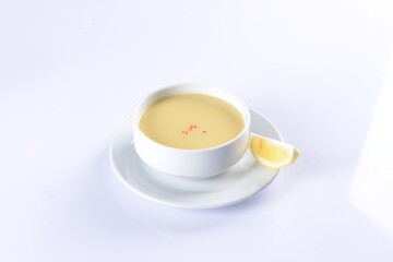 Lentil Soup with lemon and hot oil sauce, in white bowl
