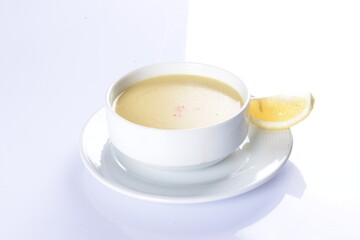 Lentil Soup with lemon and hot oil sauce, in white bowl