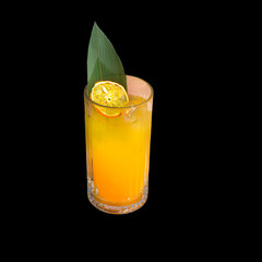Glass with fruit juice. Exotic lemonade with orange chips slice and green leaf. Isolate.