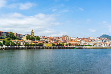 Fototapeta premium View of Portugalete town by Nervion river, and Sandra Maria basilica, Basque Country, Spain.