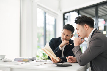 Asian business advisor meeting to analyze and discuss the situation on the financial report in the meeting room. Investment Consultant, Financial , teamwork ,brainstorming ,startup and accounting