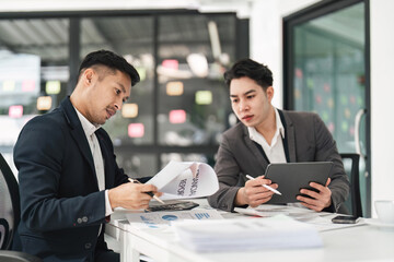 Asian business advisor meeting to analyze and discuss the situation on the financial report in the meeting room. Investment Consultant, Financial , teamwork ,brainstorming ,startup and accounting