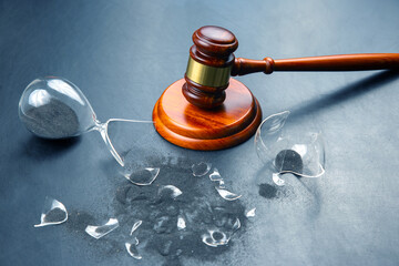 gavel of justice on the background of a broken hourglass. end of action time. expiration concept