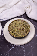 Dried herbs rosemary leaf. Dry seasoning rosemary on dark background. Spices and herbs for cooking, provence herbs