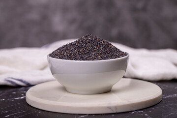 Blue poppy seeds. Spices concept. Blue poppy seeds on dark background