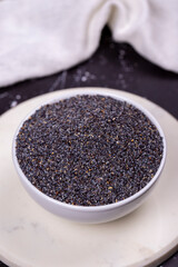Blue poppy seeds. Spices concept. Blue poppy seeds on dark background. Close up