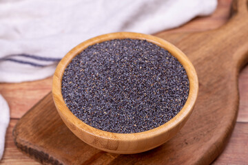 Blue poppy seeds. Spices concept. Blue poppy seeds on wooden background