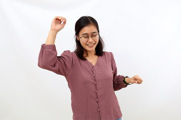 Enjoyed Young asian woman standing while dancing. Isolated on white background