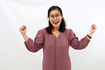 Happy successful young asian woman looking at the camera with fist hand. Isolated on white