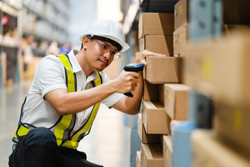 Male warehouse worker with barcode scanner in a large warehouse. Workers in a warehouse scan parcels for retail delivery and transportation.
