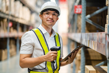 portrait of a male engineer Scan with barcode scanner, check goods in warehouse. Industrial and export business concept. logistics and export business.