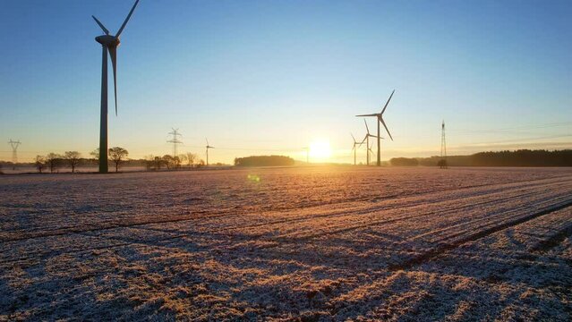 Heerstedt Lohe - Northern Germany - Wind turbines - Flight Aerial view of wind turbines rotating in the icy sunrise