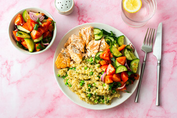 Healthy lunches, quinoa with green peas, with baked red fish salmon and fresh salad of tomato,...