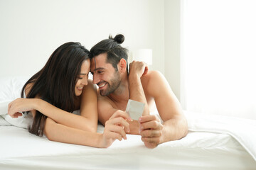 Lover couple of Caucasian adult male and Asian beautiful girl smile and laugh together when grab...