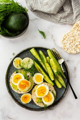 Healthy breakfasts, rice cakes with avocado and boiled eggs with dill and cucumber with spices, healthy wholesome food