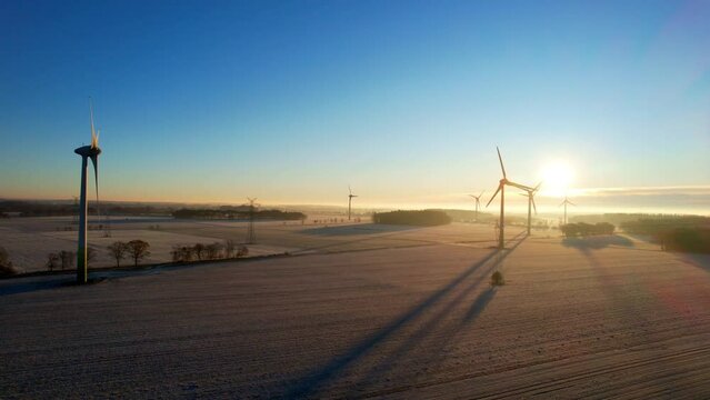 Heerstedt Lohe - Northern Germany - Wind turbines - Flight Aerial view of wind turbines rotating in the icy sunrise