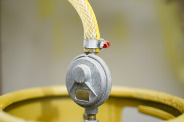 Cooking gas. Photo of a kitchen gas cylinder connected to a gas regulator. LPG, butane, propane. ....