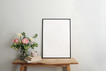 Blank black picture frame mockup. Artistic table, wooden bench still life composition with cup of...