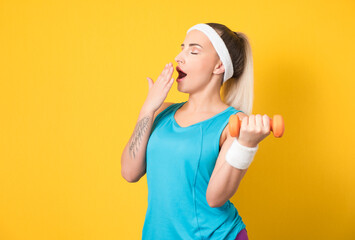 Sleepy fitness woman try to training biceps with dumbbell, lazy sporty girl, isolated on yellow background. Half length of tired sportswoman lifting weights. 80s styling