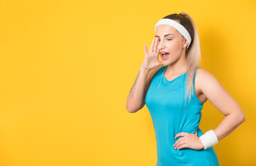 vitality woman shouting and wearing sport clothing - sportswear, isolated on yellow background. Side view of cute fitness girl while says something. 80s styling