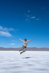 Fototapeta premium Woman jumping in the Salinas Grandes salt flat, Jujuy