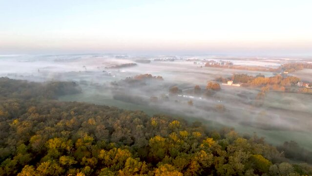 Aerial view of early morning mist over a village