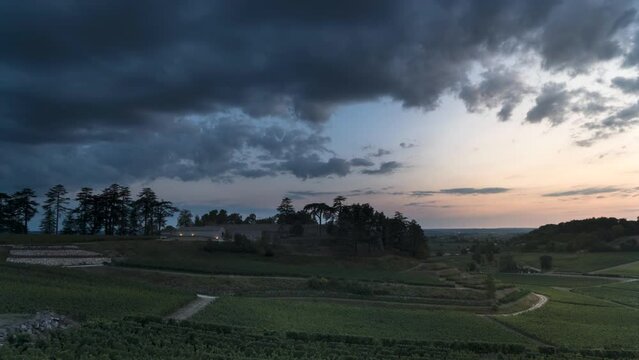 BEAUTIFUL SUNSET OVER SAINT EMILION WITH CLOUDS DASHING OVER THE VINES