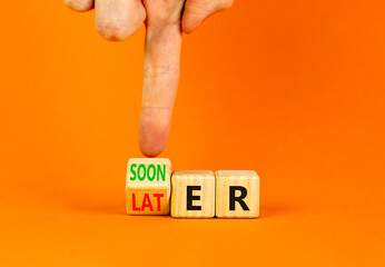 Sooner or later symbol. Businessman turns wooden cubes and changes the word Later to Sooner....