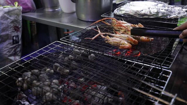 Seafood grilling, street food in Yaowarat night market, Thailand