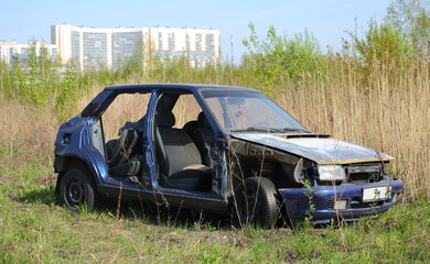 An old abandoned semi-disassembled car on the outskirts of the city, Dal'nevostochniy Prospekt, St. Petersburg, Russia, May 2023