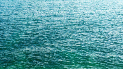 Blue sea water surface. Light ripples, waves on the sea. Space  for using advertisement of traveling, vacation, resort. Mediterranean style. Background.