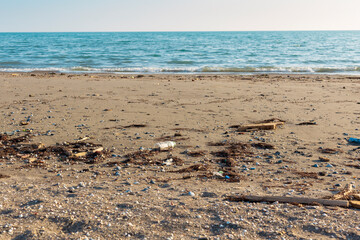 Beach pollution. Plastic bottles and other trash on sea beach. Ecological concept