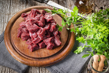 Beef stew prepared on a chopping board.