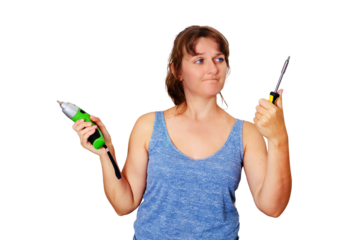 A woman chooses between an electric and a mechanical screwdriver, isolated on a white background. Repair in a new apartment on their own.