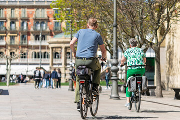 Tourists on bicycles through the Old Town. Castle Plaza. Pamplona