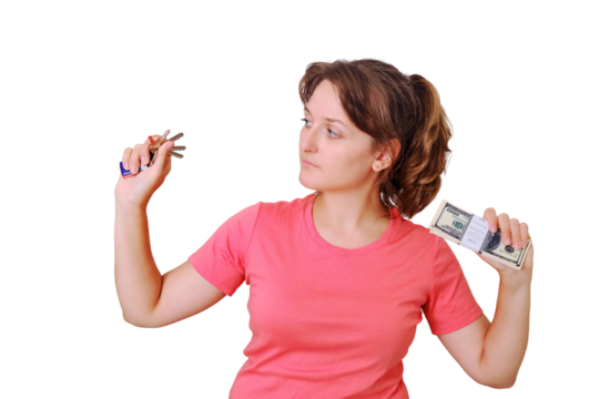 A young woman looks at the keys to the new apartment, isolated on a white background. Money and keys to the built house in hand, isolated on a white background. US dollars in exchange for new housing