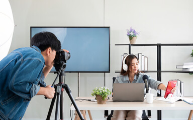 Asian photographer man use camera for live video while tutor girl setup gadget for record tutorial...