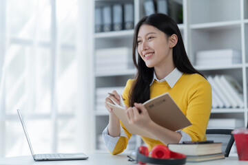 Young student who learns with online platform at the library or co-working space