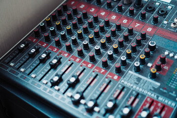 Detailed view of sound mixer featuring an array of buttons and sliders for audio customization