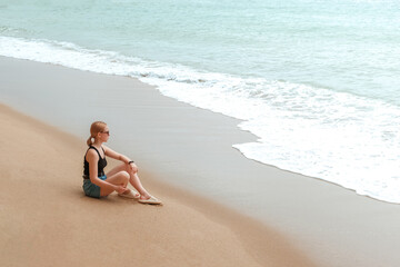 Travel. Travelers woman on the coast of the ocean on a tropical island. Solitude, wildlife, mental health, conscious travel, travel and active life concept. Travel banner