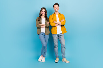 Full body length photo of positive young office managers wear smart casual clothes folded arms satisfied their job isolated on blue color background