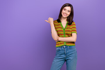 Portrait of positive lovely girl stylish hairdo dressed striped cardigan indicating empty space offer isolated on violet background