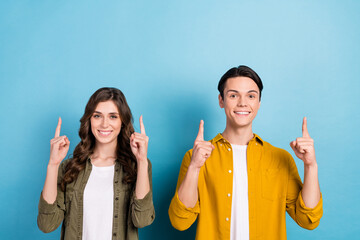 Portrait photo of cheerful good mood smiling couple friendship wear shirts direct fingers mockup...